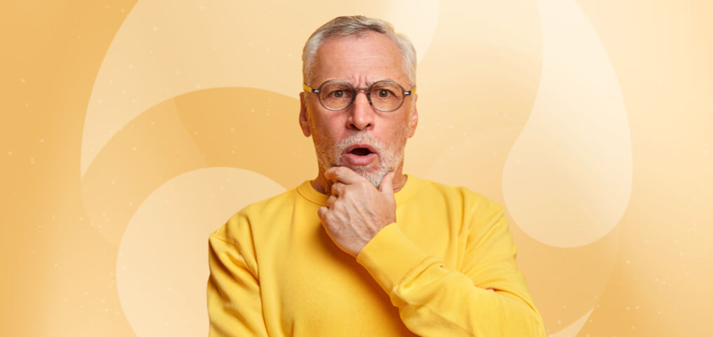 man in yellow shirt posing with a surprised face