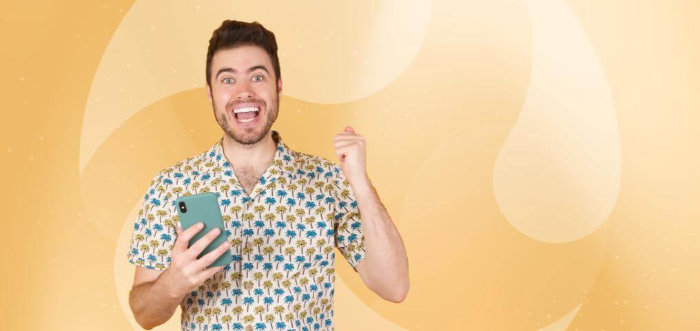 man with phone in hand, looking happy and excited