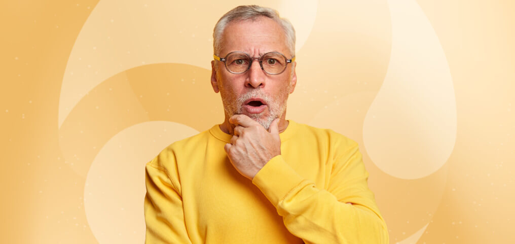 man in a yellow shirt, with a surprised facial expression