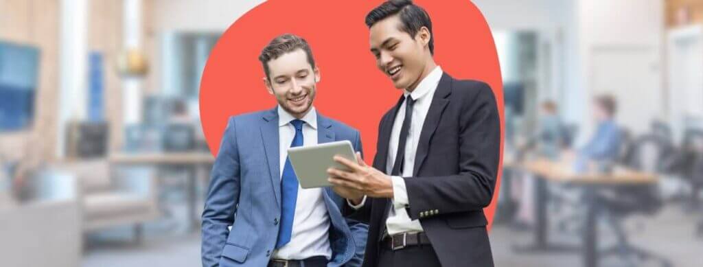 two businessmen reading something on a tablet