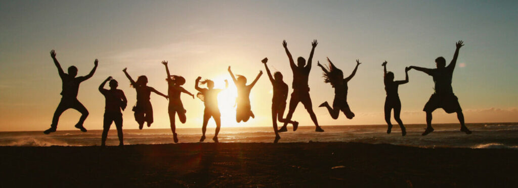 a group of people jumping in sunset