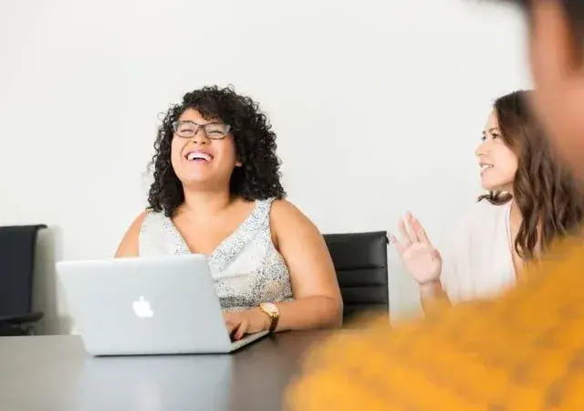 women smiling and talking during work