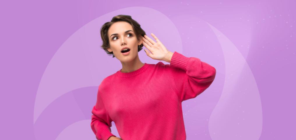 woman in a pink sweater, listening