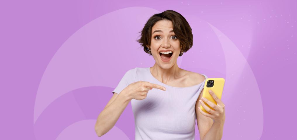 woman excited after seeing something on smartphone